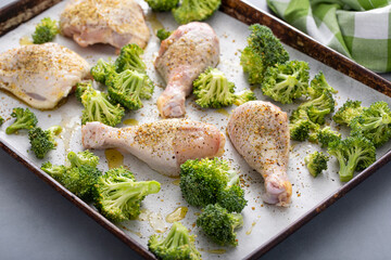Canvas Print - Chicken drumsticks and thighs with broccoli sheet pan dinner or lunch