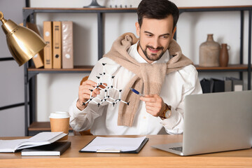 Poster - Male tutor with molecular model giving online Physics lesson at home