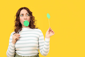 Poster - Woman with paper clover on yellow background. St. Patrick's Day