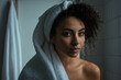 young woman, refreshed with bath towel after shower, critical skeptical worried or lazy tired