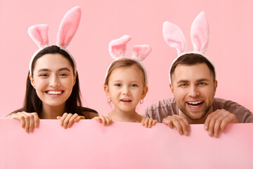 Wall Mural - Happy family in Easter bunny ears on pink background