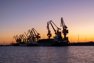  Gantry crane and cargo ship in the evening