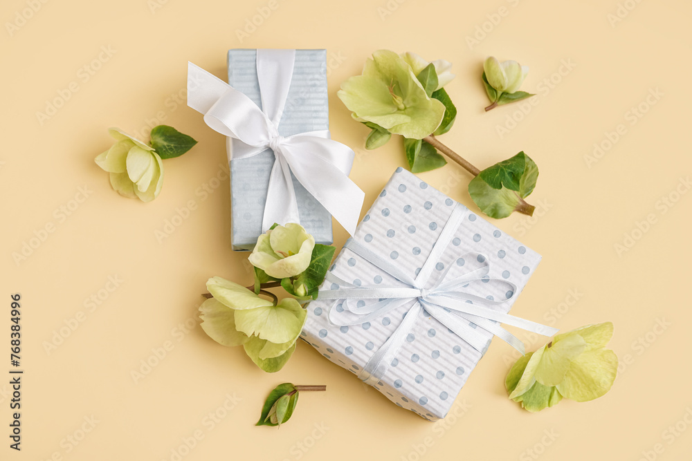 Gift boxes and beautiful flowers on yellow background