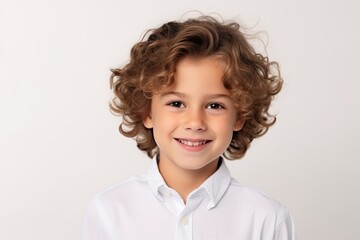 Sticker - Portrait of a cute little boy with curly hair on white background