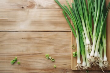 Wall Mural - A commercial flat lay of fresh green onions neatly arranged on a wooden cutting board on a table