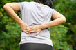 woman's hand he is caught at the waist and her back is painful at the back in the room. health concept