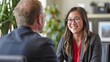 © Intelligent Horizons - A confident and smiling woman in a business setting,presumably a customer,is having a friendly discussion and consultation with a male banker or financial adviser They appear to be collaborating