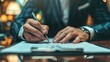 © ISK PRODUCTION - Close up hands of businessman in a suit signing a document at the desk in office