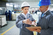 © peopleimages.com - People, clipboard or warehouse in logistics, safety or hat in meeting, building or product delivery. Manager, female employee or helmet in supply chain, quality assurance or factory stock checklist