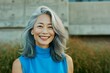 Portrait of a beautiful asian woman with blue hair smiling