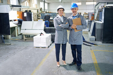 Poster - Professional people, printing and industry in warehouse with clipboard for distribution, admin and packaging. Man, woman and happy in factory with portrait for production, manufacturing and teamwork