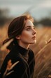 Portrait of a beautiful young woman in a wheat field at sunset
