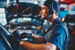 © studioworkstock - mechanic with headset monitoring car diagnostics