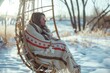 woman in a hanging chair wrapped in a blanket on a brisk spring morning