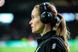 woman with var headset analyzing a soccer foul