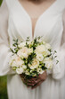 Bouquet of white roses in hands