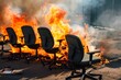 © altitudevisual - office chairs lined up and on fire like a bonfire
