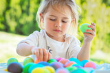 Fototapeta Dmuchawce - Happy Baby Coloring Easter Eggs