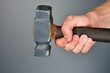 © altitudevisual - hand holding hammer for a science experiment on force