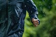 © altitudevisual - person jogging with raindrops visible on waterproof jacket