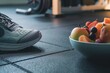 closeup of sneakers next to a bowl of mixed fruits on gym floor