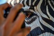 person using camera to take photo of zebras eye