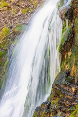 Canvas Print - Falling water in a waterfall on a cliff