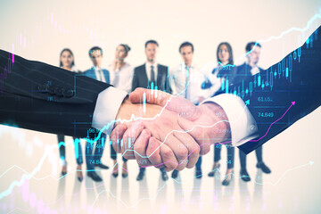 Wall Mural - Close up of two businessmen shaking hands with their diverse blurry colleagues in the background. Concept of business partnership, management and financial growth with forex chart. Double exposure.