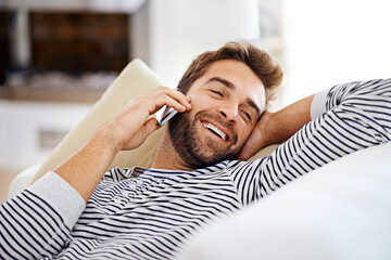Poster - Happy man, relax or phone call in home talking or speaking in living room for communication or chat. Smile, peace or person laughing in a mobile conversation on couch or sofa in a house for a break