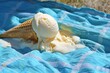 ice cream cone toppled over, melting onto a blue picnic blanket
