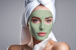 The face of a girl with a green mask applied to her face