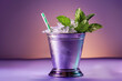 A mint julep cocktail in a silver cup, garnished with fresh mint leaves and a straw, isolated on a gradient background 