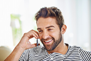 Poster - Happy, man or phone call in home talking or speaking in living room for communication or chat. Smile, mobile or male person laughing in conversation to relax on couch or sofa in a house for a break