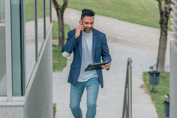 businessman with tablet and mobile phone on the street