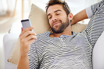 Poster - Man, smile and smartphone on sofa in living room for for communication, social media and or texting. Cellphone, happy and male person for internet browsing, notification or online chat on weekend