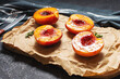 Baked peaches with honey and cinnamon on black stone background. summer dessert.