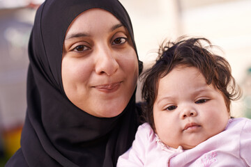 Wall Mural - Muslim, family and portrait of mother with baby in home for bonding, smile and calm together. Parenting, happy and Islamic mom with newborn infant for love, childcare or support in living room