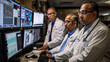 © sommersby - Three healthcare professionals intensely review critical data on multiple monitors in a hospital setting