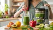 A woman is using a juicing machine to make a healthy green juice in her kitchen. This vegan diet is detoxifying and uses cold-pressed extraction to maximize nutrient intake for a nutritious smoothie.