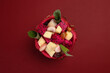 Beautiful Mangosteen mango dragon fruit cube fruit salad in dragon fruit skin bowl on red background