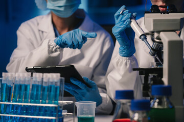 Wall Mural - life scientists researching in laboratory. focused female life science professional pipetting soluti