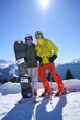 © nuclear_lily - Snowboarder and a skier, share a moment against the backdrop of stunning mountains.