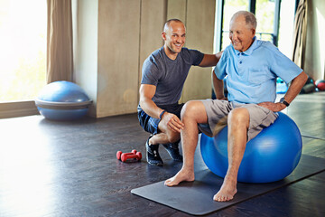 Canvas Print - Physiotherapist, helping and senior man with yoga ball, training and elderly support for care. Men, gym and exercise for health, wellness and coaching with dumbbell for mature rehab and wellbeing