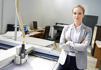 Poster - Woman, publisher and machine at office with confidence for production, distribution and administration. Portrait, female person and entrepreneur with startup business in logistics and arms crossed