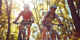 Two men riding bicycles in woodland path on sunny summer day. Athletes on their bikes in summer forest.