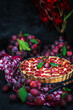 Fresh homemade plum tart or cake on dark background