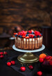 Delicious homemade Three chocolate mousse cake decorated with fresh berries