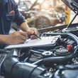 Professional mechanic inspecting car engine and writing checklist in an auto repair shop, showcasing thorough maintenance and repair estimation.