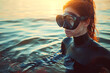 Woman with scuba mask enjoying sunset in ocean waters