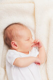 Fototapeta Krajobraz - Newborn Baby Asleep on Cream Blanket